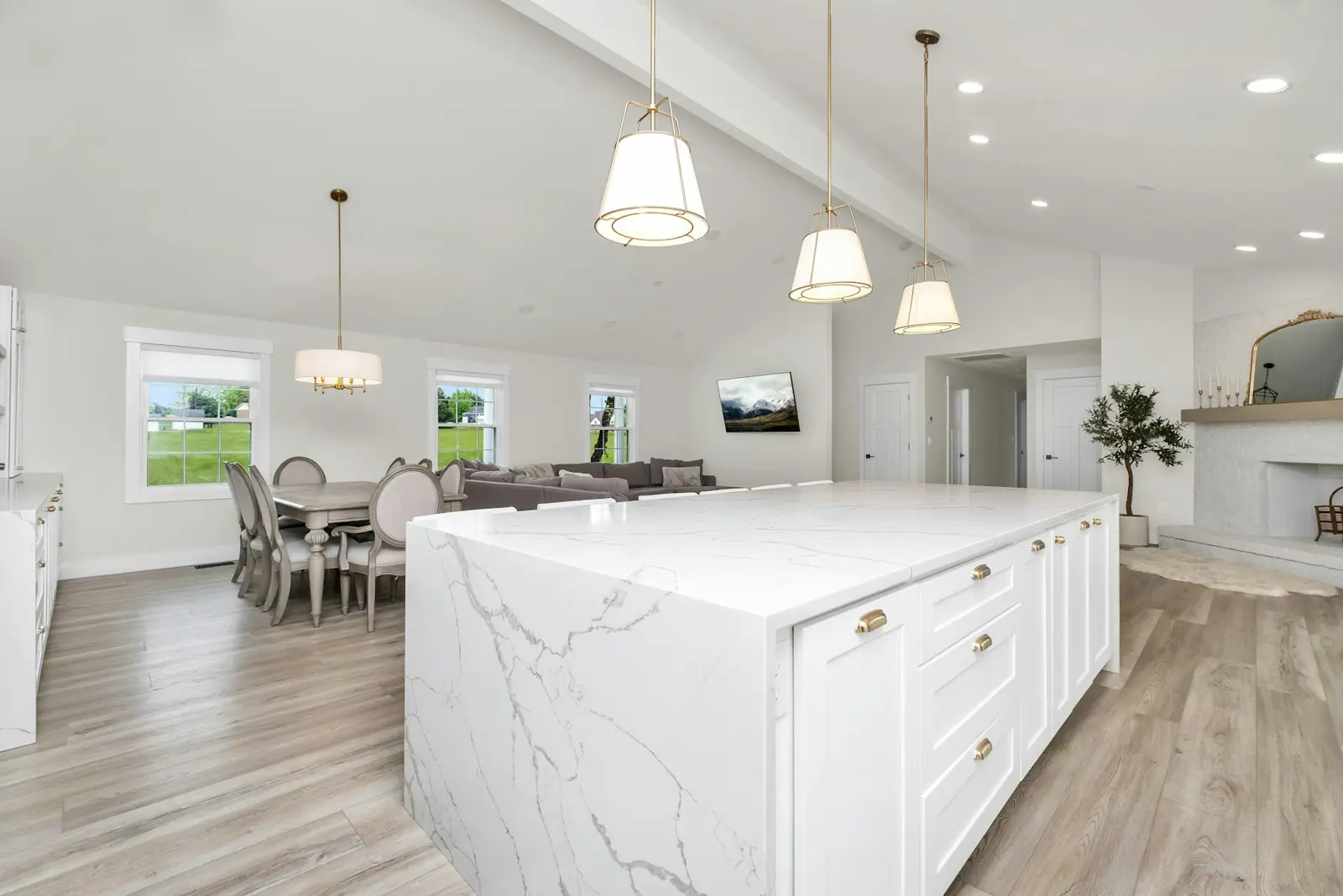 Gleaming white kitchen with a marble island